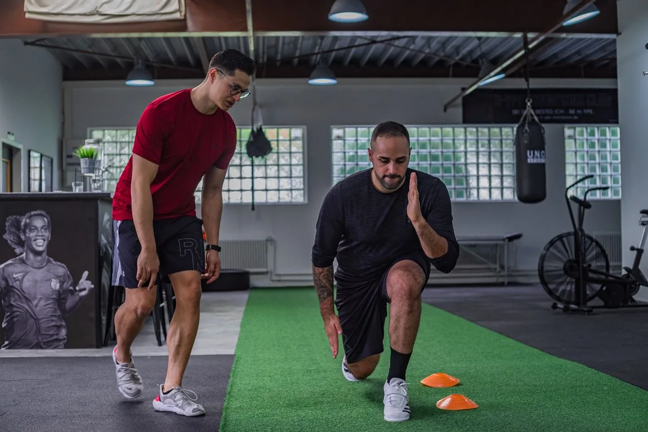 A coach guiding a client through a training session